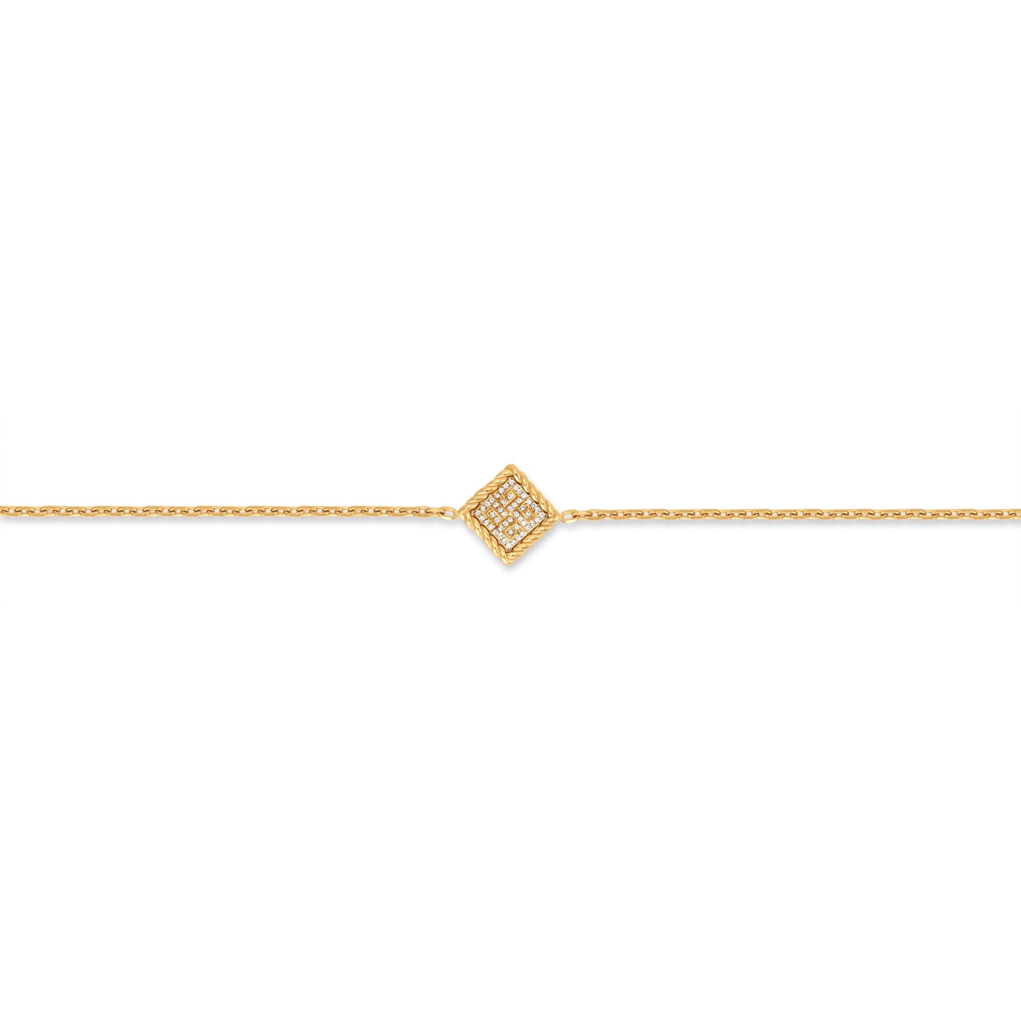 Gold-toned bracelet with a central diamond-shaped charm. The charm has a twisted wire border and is paved with clear crystals