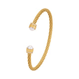 Gold-toned twisted bangle with two white pearls, each end featuring a gold-toned cap with clear crystals and a Greek key patt
