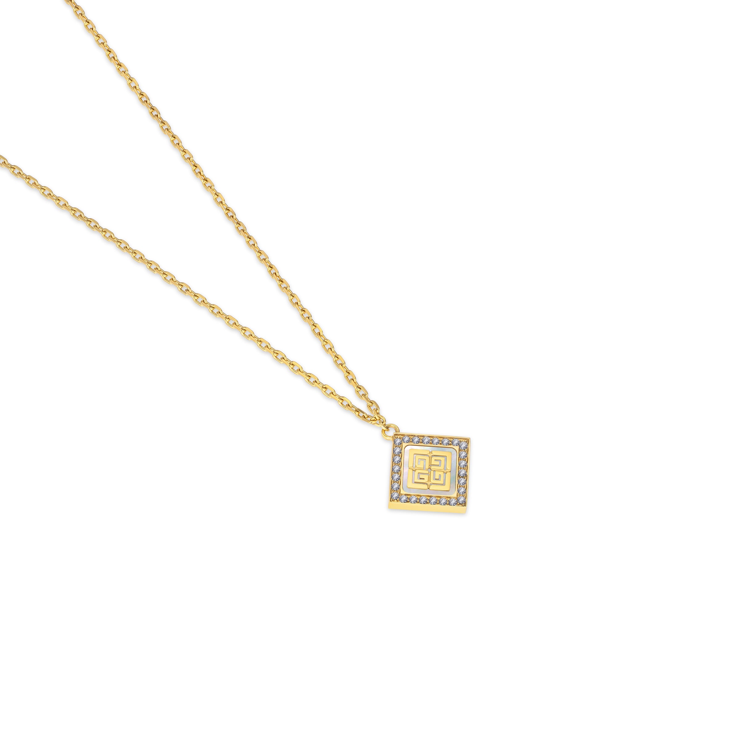 Gold-toned necklace with a square pendant featuring a white mother-of-pearl inlay, gold-toned geometric pattern, and clear cr