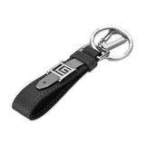 Black textured leather keyring with a grey loop, silver-finished "G" buckle, and a silver-finished ring with "GUY LAROCHE" en