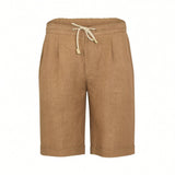 Tan linen shorts with elasticated waist, cream drawstring with light brown tips, front pleats, side pockets, and cuffed hems.