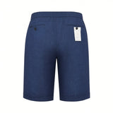 Dark blue textured shorts with an elasticated waist, a buttoned back pocket, and another back pocket with a white tag.