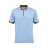 Light blue short-sleeve polo shirt with a brown collar and cuffs, both featuring white and brown stripes. It has a brown quar