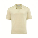Pale yellow short-sleeved polo shirt in a textured knit fabric, featuring a spread collar and a V-neck placket.