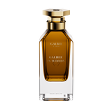 A front-facing view of the Galbee Is Woody perfume bottle, highlighting the gold-etched branding and the signature hexagonal emblem on the glass.