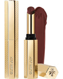 Guerlain KissKiss Honey-Infused Matte Lipstick in its signature slim golden honeycomb case, shown with an open deep burgundy-brown lipstick bullet and a velvety color smudge texture, available at blue salon.
