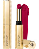Guerlain KissKiss Honey-Infused Matte Lipstick in its signature slim golden honeycomb case, alongside an open magenta-fuchsia lipstick bullet and creamy texture swatch, from blue salon.