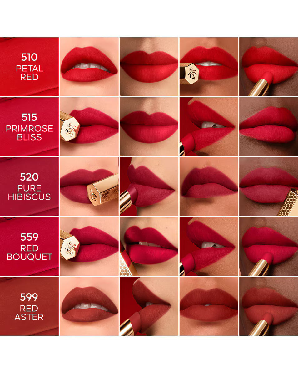 A shade reference guide displaying five velvety matte red lip swatches across diverse skin tones, featuring Guerlain shades Petal Red, Primrose Bliss, Pure Hibiscus, Red Bouquet, and Red Aster from blue salon.