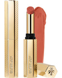 Guerlain KissKiss Honey-Infused Matte Lipstick in its signature slim golden honeycomb tube, featuring an open nude-pink lipstick bullet next to a creamy texture smudge, available at blue salon.