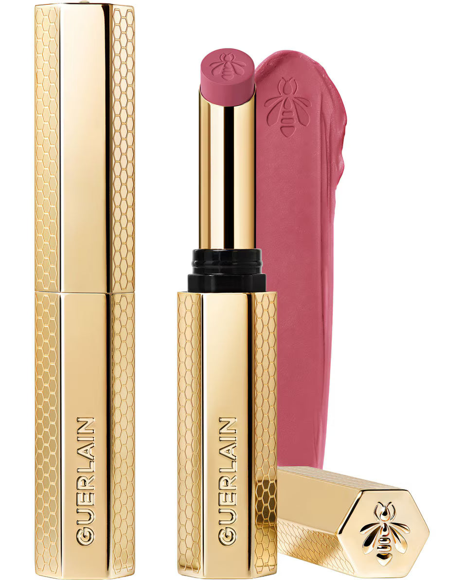 Guerlain KissKiss Honey-Infused Matte Lipstick in its signature slim golden honeycomb tube, featuring an open deep plum-berry lipstick bullet next to a velvety color smudge, available at blue salon.