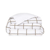 White duvet cover and pillow case set. The duvet cover has a black and gold-toned grid pattern; the pillow case is solid whit