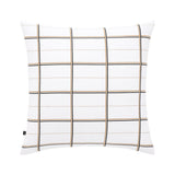 White pillowcase with a grid pattern of thin black and gold-toned lines. A small black tag is on the bottom left edge.