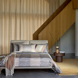 Hugo Boss Taman bedding set with duvet cover, flat sheet, and four pillowcases in grey, beige, and off-white horizontal strip