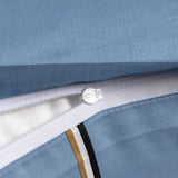 Light blue fabric duvet cover with a white zipper and a decorative stripe of gold-toned, white, and black bands.