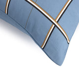 Light blue duvet cover with intersecting diagonal stripes in white, black, and brown.