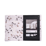 White duvet cover and pillow case set with a pattern of abstract dark brown and light brown floral shapes.