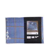 Light blue duvet cover and pillow case set with a plaid pattern of thin white, black, and brown lines.