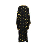 Back view of the Hayas Boutique black kaftan showing the fluid drape of the chiffon fabric and the consistent pattern of gold embroidered polka dots.