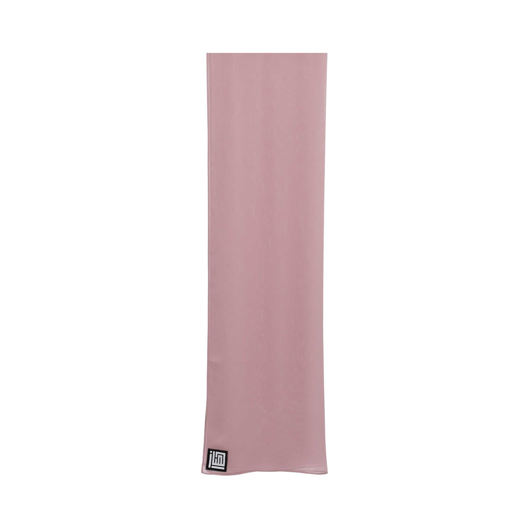 Close-up image of the sheer dusty rose hijab from Hayas Boutique, showing the smooth, lightweight fabric and the black logo tag on the bottom corner.