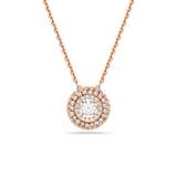 A high-resolution close-up studio shot of the Swarovski Sublima pendant, showcasing the large round-cut white center stone surrounded by concentric rows of white pavé crystals set in an 18K rose gold finish.