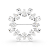 A high-resolution direct frontal studio shot of the Swarovski Matrix brooch against a white background, highlighting the circular wreath layout composed of outward-pointing pear-cut white crystals.