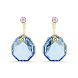 A high-resolution direct frontal studio shot of the Swarovski Gema earring jackets pair, highlighting the symmetrical octagon-cut blue crystals suspended beneath delicate round violet crystal studs on an 18K gold-plated base.