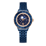 A high-resolution direct frontal studio shot of the Swarovski Octea Moon watch against a white background, highlighting its circular faceted blue crystal bezel, stellar moon phase dial, and blue-finish multi-link bracelet.