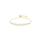 A high-resolution direct frontal studio shot of the Swarovski Mesmera bracelet arranged symmetrically, showcasing the transition from its uniform round tennis stones to the central mixed-cut crystal cluster on a gold-plated frame.