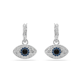 A high-resolution front studio view of the Swarovski Symbolica earrings, showcasing the sparkling clear crystal huggie hoops and the detailed blue and black evil eye drops hanging in perfect symmetry.
