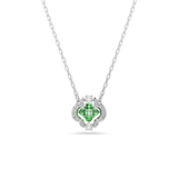A high-resolution front studio view of the Swarovski Una Angelic pendant, highlighting the vibrant mixed-cut green crystals arranged in a clover shape within a clear crystal-lined rhodium-plated frame.