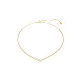 A high-resolution overhead studio view of the Swarovski Mesmera necklace laid flat in a circular shape, highlighting the uniform line of round-cut white crystals and the striking mixed-cut V-centerpiece set in 18K gold plating.