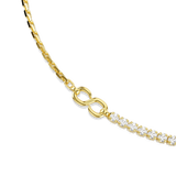A close-up studio shot detailing the center connection point of the Swarovski Matrix necklace, where the continuous prong-set round white crystals meet the polished 18K gold-finish infinity link and box chain.
