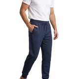 Navy blue tapered jogger trousers with an elasticated drawstring waistband, side pockets, and cuffed ankles.