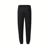 Black sweatpants with an elasticated waist, ribbed cuffs, and a small back pocket. A vertical blue and green patterned stripe