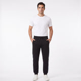 Black jogger trousers with an elastic drawstring waist, cuffed ankles, and a blue and green patterned stripe down each side.