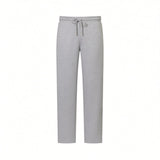 Grey melange sweatpants with an elasticated drawstring waist, silver-toned tips, and subtle vertical text on the right leg.