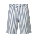White and light blue vertically striped shorts with an elastic waistband and a white drawstring tied in a bow.