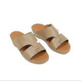 Pair of light beige open-toe sandals with two wide straps and a tan footbed.