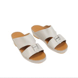 Pair of light grey kids' traditional slip-on sandals with a silver-toned buckle on the front strap and a light brown footbed.