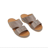 Taupe leather slip-on sandals with tan insoles. Each sandal features two wide straps, the front one with a silver-toned buckl