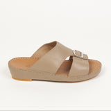Taupe leather slip-on sandal with two wide straps, one featuring a silver-toned buckle. Tan footbed with visible stitching.