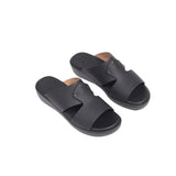Pair of black Fares Kids junior gommato open-toe sandals with a smooth matte finish and metallic stud details on the upper st