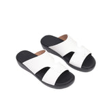 Pair of white junior gommato sandals with black soles and a two-strap upper design.