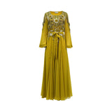 Front view of a mustard yellow floor-length SHAIRA gown featuring heavy gold and green floral embellishments on the bodice, long sleeves with pleated cuffs, and a matching fabric belt tied at the waist.