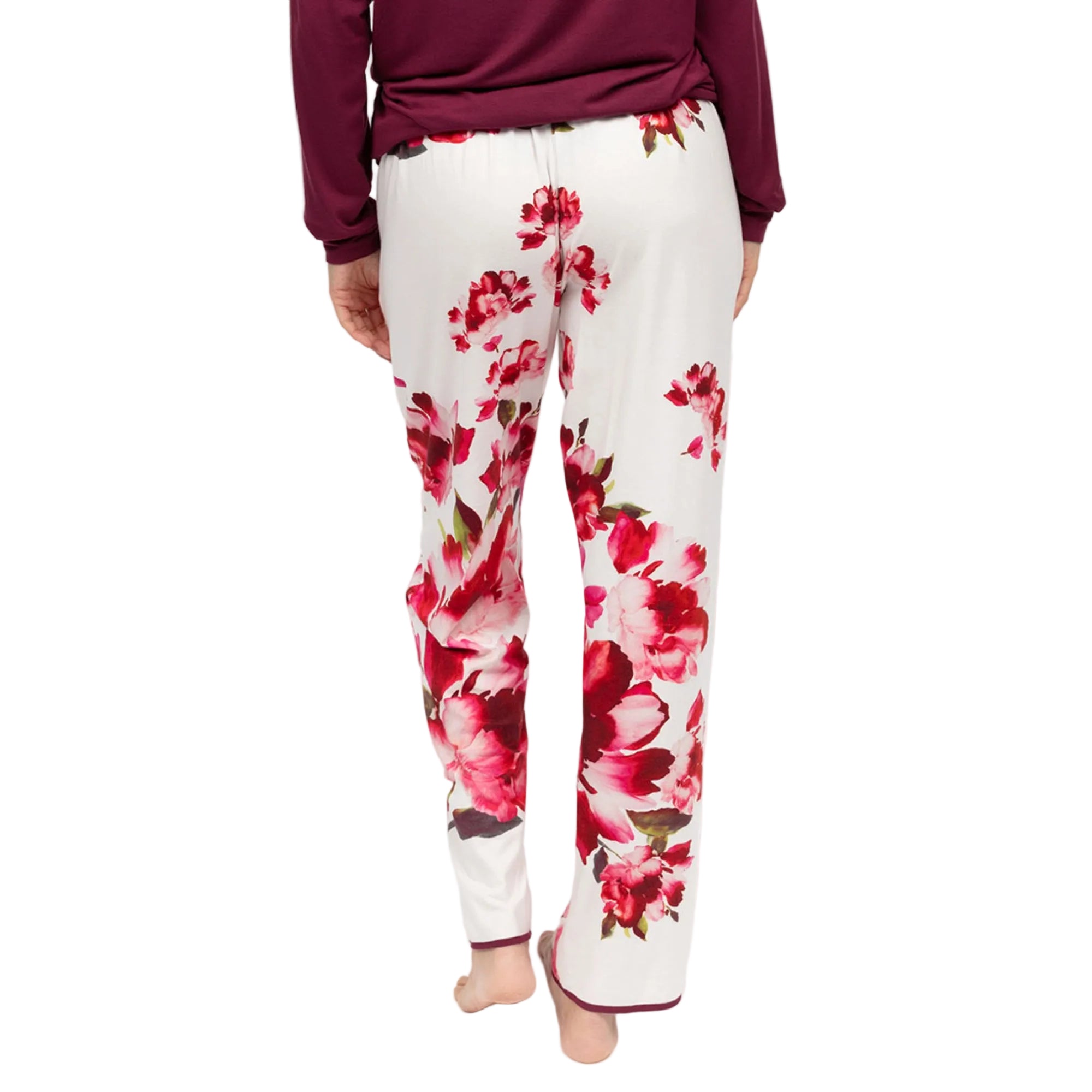 White jersey pyjama bottoms with an elasticated waist, featuring a red floral print and ox blood trim on the hems.
