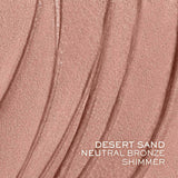 A swatch of shimmery desert sand neutral bronze tint, applied in wavy strokes.