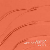 Matte apricot-orange tint swatched in several curved strokes, showing its creamy texture and finish.
