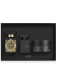 Initio Parfums Privés Oud for Greatness luxury gift set cleanly nestled inside a matte black insert, displaying the signature geometric gold-detailed perfume bottle, a sleek black hair perfume bottle, and a matching body cream jar.