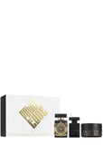 Initio Parfums Privés Oud for Greatness ritual set featuring a 90ml Eau de Parfum, hair perfume, and 200ml body cream standing next to a white textured presentation box embossed with bold gold "Power of Oud" lettering.