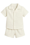 Off-white short-sleeved shirt with revere collar and patch pocket, paired with matching relaxed-fit shorts.
